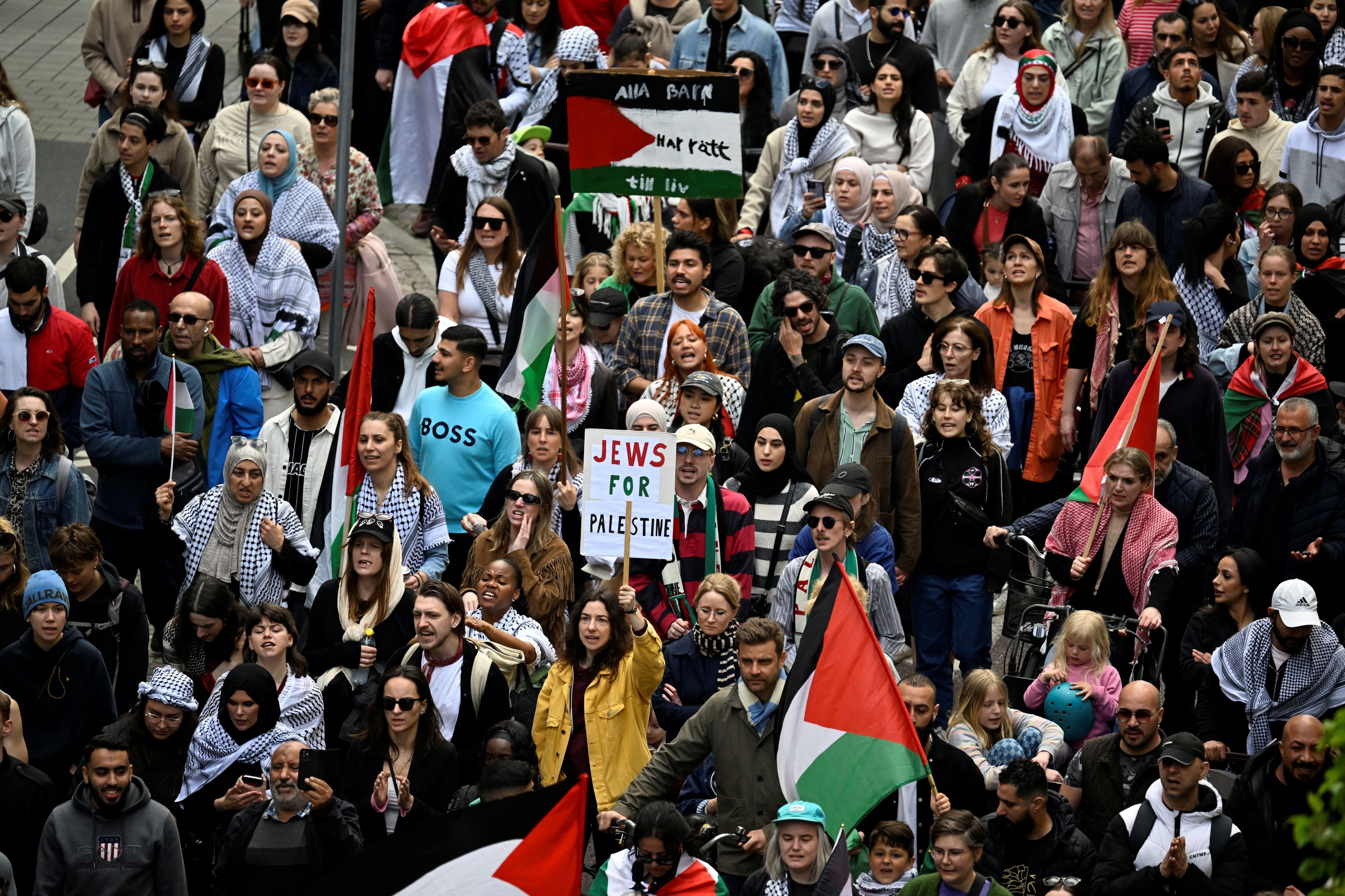 Protesters hold Palestinian flags and signs during the "Stop Israel" demonstration, against Israel's participation in the Eurovision Song Contest due to its ongoing offensive in Gaza against Hamas, in Malmo, Sweden, May 11, 2024. TT News Agency/Johan Nilsson via REUTERS      ATTENTION EDITORS - THIS IMAGE WAS PROVIDED BY A THIRD PARTY. SWEDEN OUT. NO COMMERCIAL OR EDITORIAL SALES IN SWEDEN.