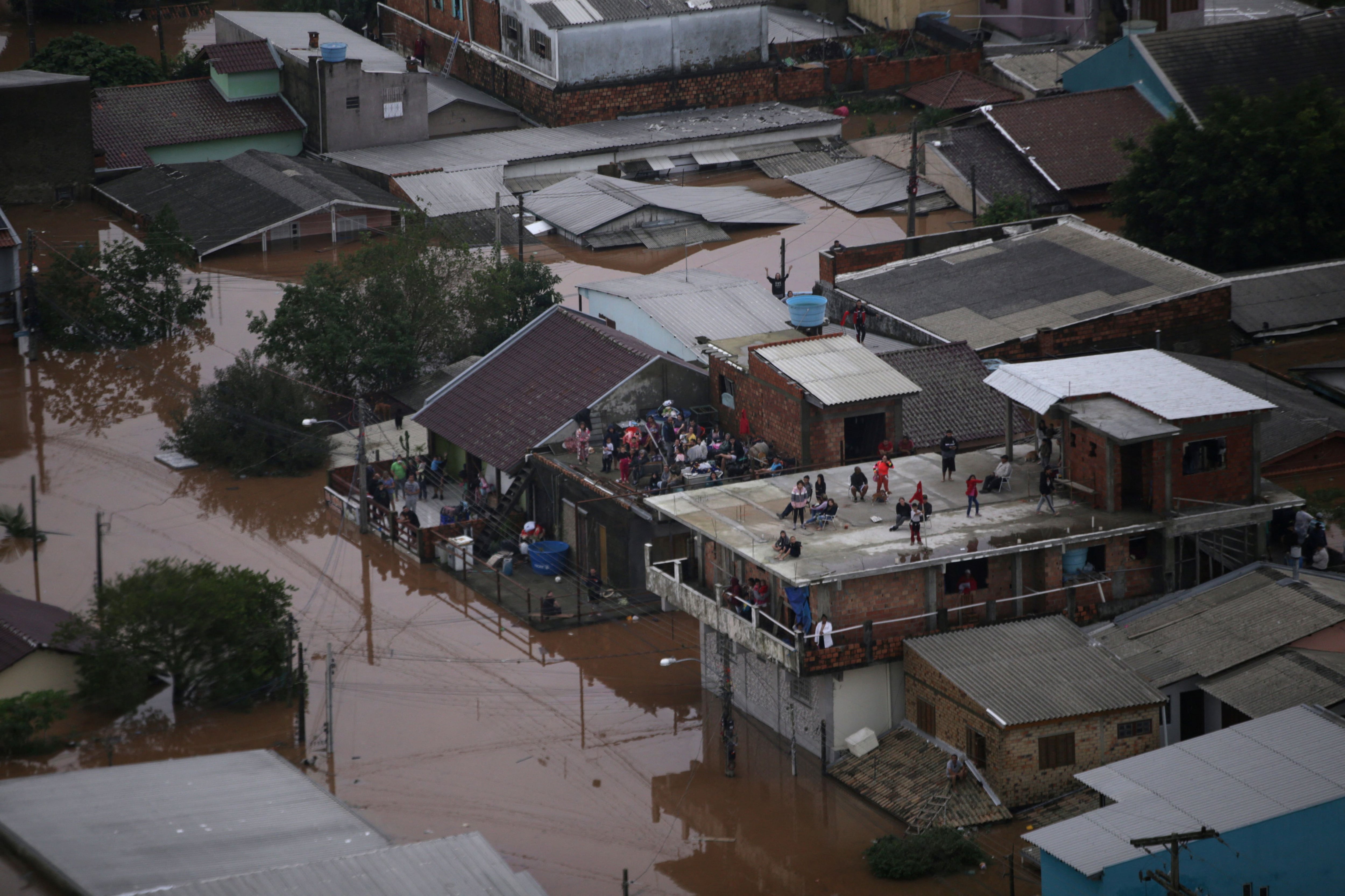 Desde las calles anegadas o desde el aire, las imágenes son desoladoras: casas a las que apenas se le ven los techos, gente que lo perdió todo, y el centro de la moderna capital de Rio Grande do Sul , de 1,4 millones de personas, completamente inundado (REUTERS/Renan Mattos)