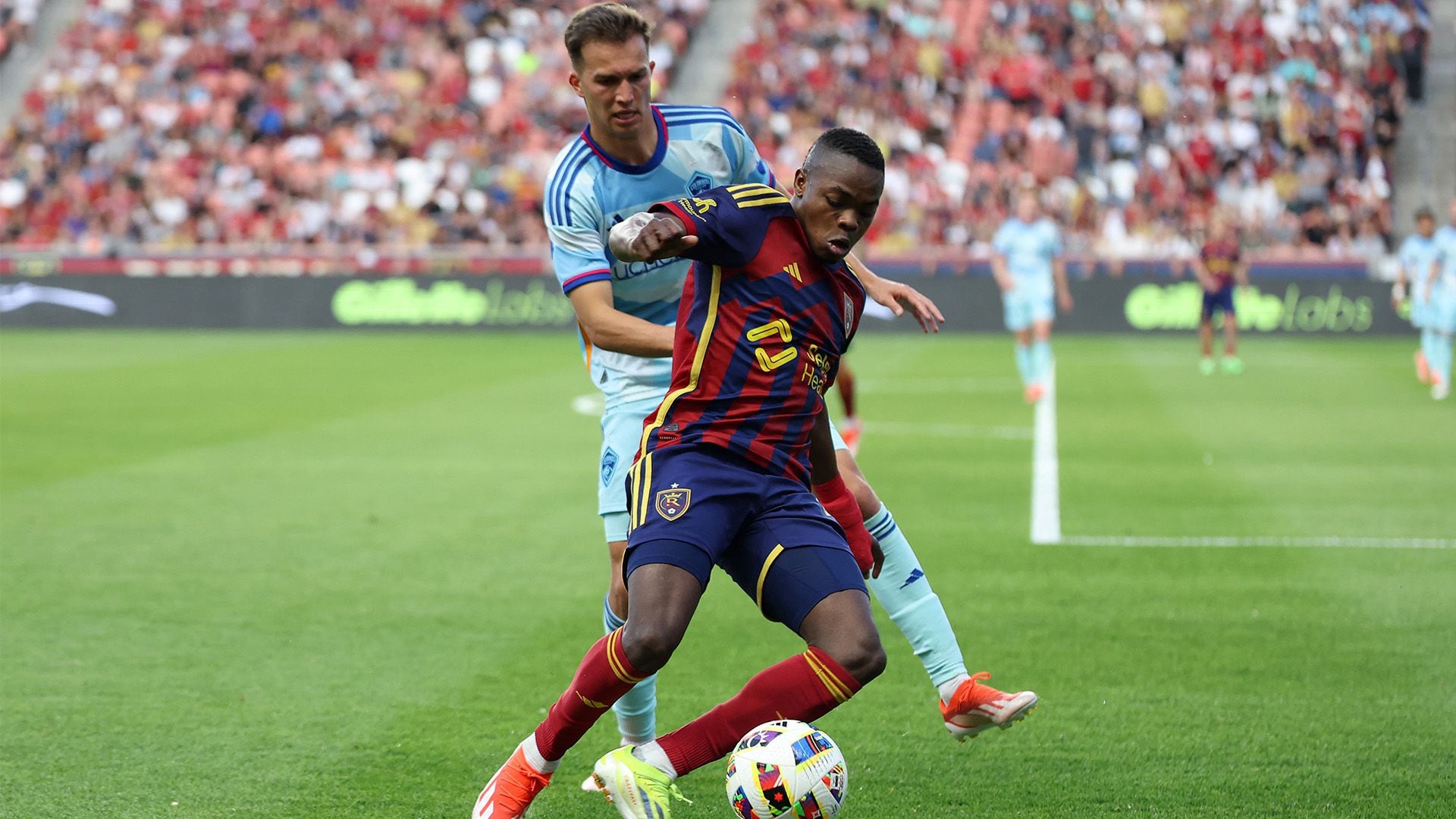 May 18, 2024; Sandy, Utah, USA; Colorado Rapids midfielder Cole Bassett (23) and Real Salt Lake midfielder Andres Gomez (11) fight for a ball during the first half at America First Field. Mandatory Credit: Rob Gray-USA TODAY Sports