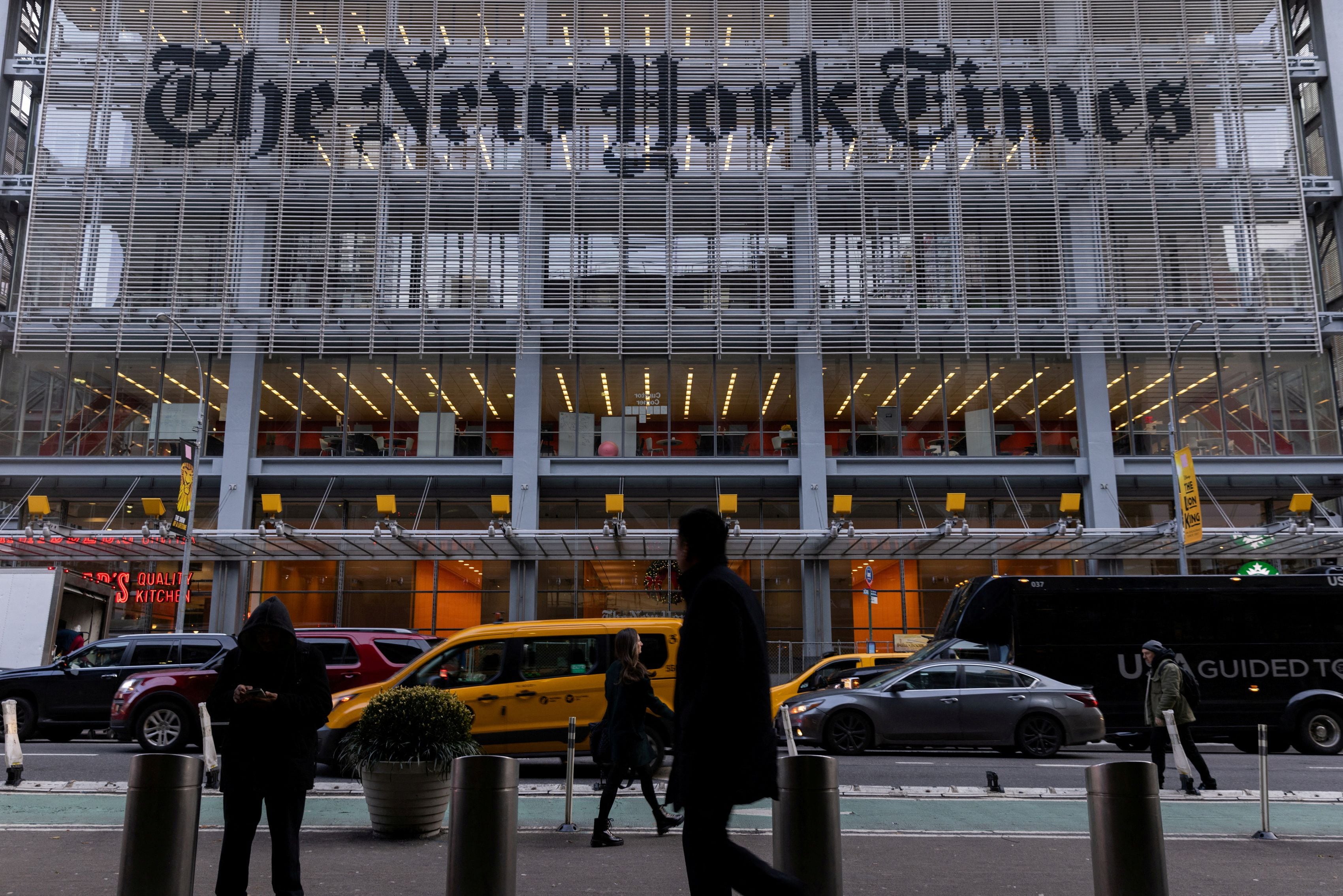 FILE PHOTO: Pedestrians walk by the New York Times building in Manhattan, New York, U.S., December 8, 2022.  REUTERS/Jeenah Moon/File Photo