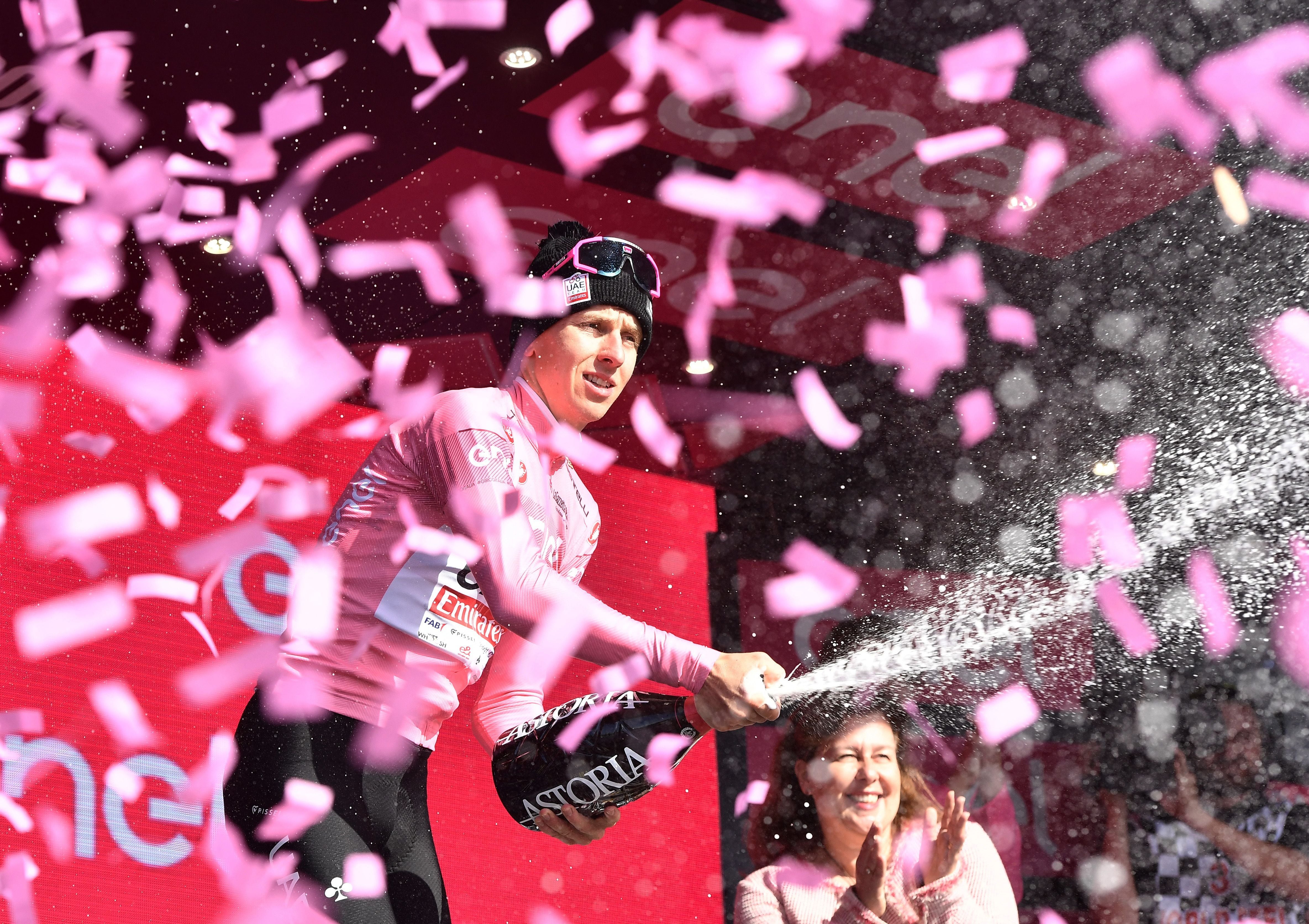 Cycling - Giro d'Italia - Stage 8 - Spoleto to Prati di Tivo - Italy - May 11, 2024 UAE Team Emirates' Tadej Pogacar celebrates on the podium wearing the maglia rosa jersey after winning stage 8 REUTERS/Jennifer Lorenzini