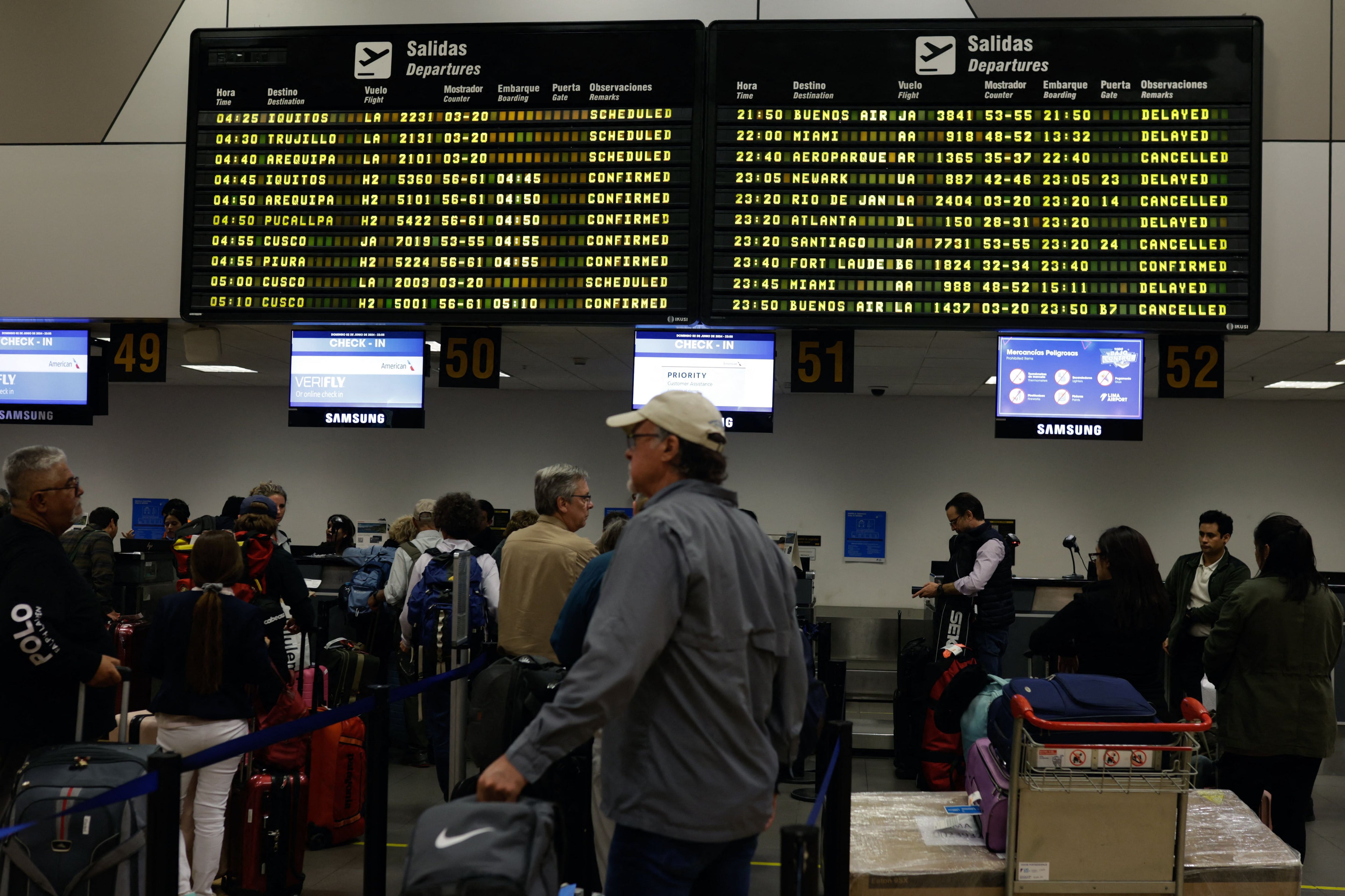 Travelers remain stranded at the Jorge Chavez International Airport in Callao, a province adjacent to Lima, after flights were cancelled due to a failure of the runway lights, on June 3, 2024. The incident caused chaos with at least 47 departure flights delayed and 37 arrival flights diverted to other countries or airports in other regions of Peru. (Photo by Juan Carlos CISNEROS / AFP)